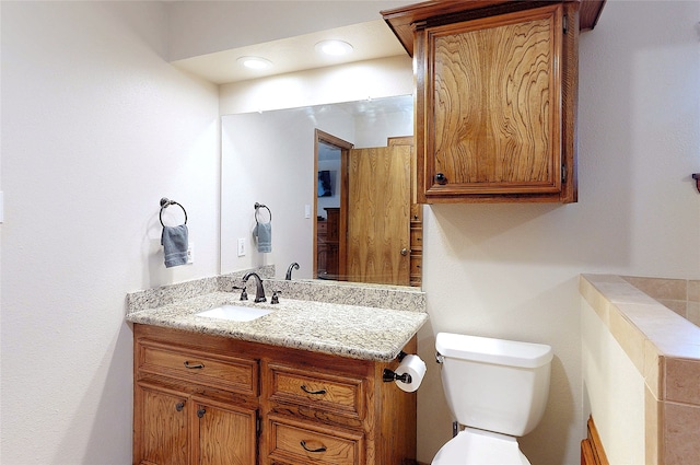 half bathroom with vanity and toilet