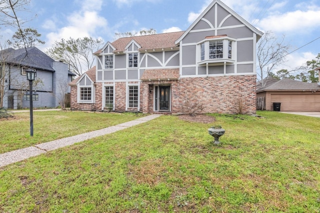 tudor-style house with brick siding, a front lawn, and stucco siding