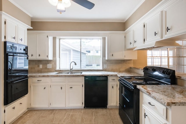 kitchen with black appliances, white cabinetry, and a sink