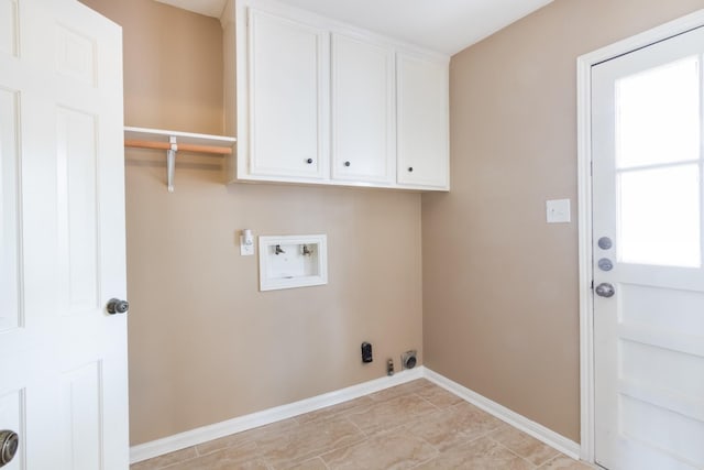 clothes washing area featuring gas dryer hookup, hookup for an electric dryer, washer hookup, baseboards, and cabinet space