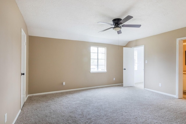 empty room with ceiling fan, baseboards, a textured ceiling, and light colored carpet