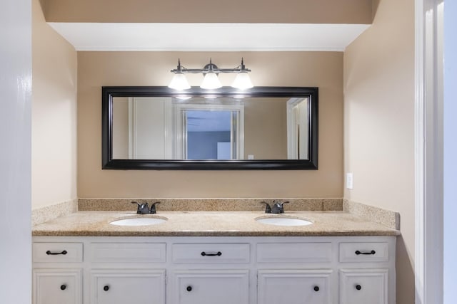 bathroom featuring a sink and double vanity