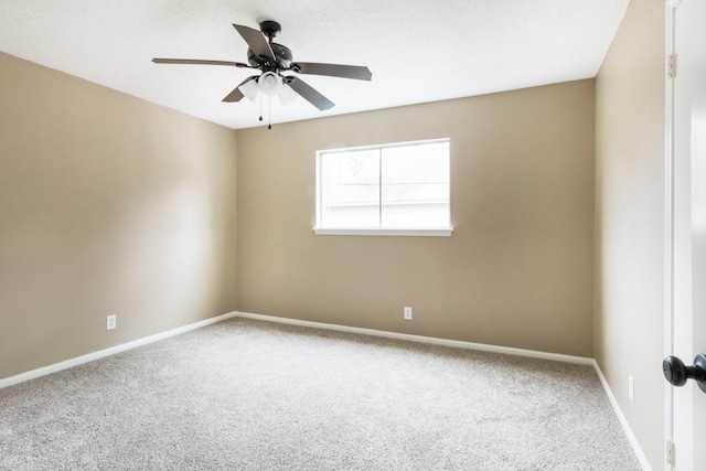 empty room with carpet floors, ceiling fan, and baseboards