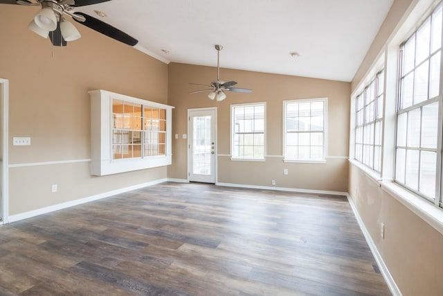 interior space featuring baseboards, vaulted ceiling, and dark wood-style flooring