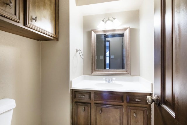 bathroom featuring toilet and vanity