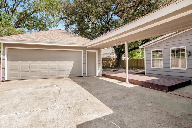 detached garage featuring fence