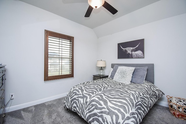 bedroom with lofted ceiling, baseboards, dark carpet, and ceiling fan