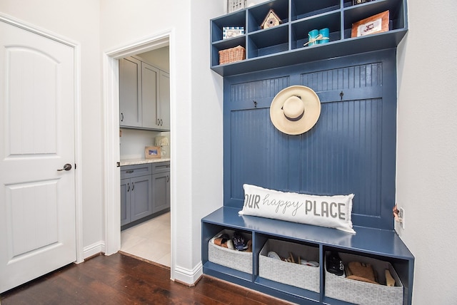 mudroom featuring dark wood-style flooring and baseboards