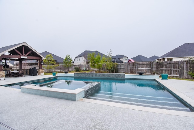 view of pool with a patio, a fenced backyard, a grill, a gazebo, and a residential view