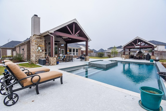 view of pool with a fenced in pool, a hot tub, a gazebo, an outdoor hangout area, and a patio area