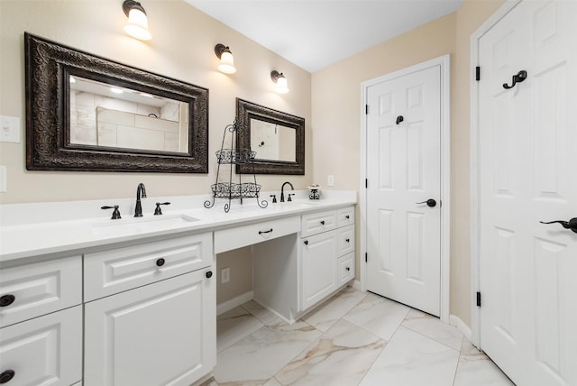 bathroom featuring marble finish floor, a sink, baseboards, and double vanity