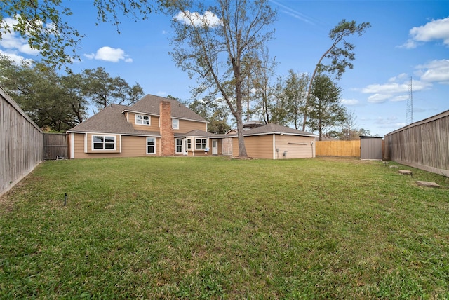 view of yard featuring a fenced backyard and an outdoor structure