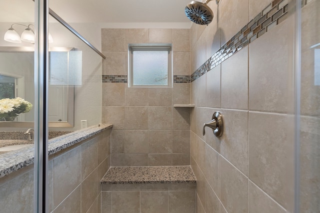 bathroom featuring a sink and tiled shower