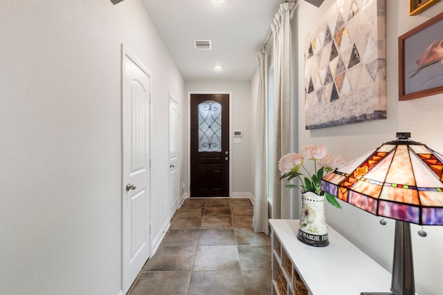 doorway with recessed lighting, visible vents, and baseboards