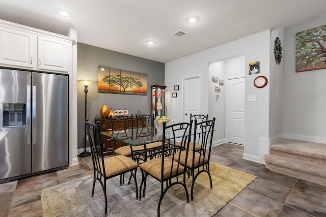 dining room featuring stone finish floor, recessed lighting, visible vents, and baseboards