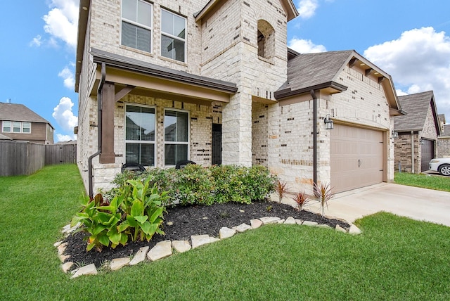 view of front of home featuring brick siding, a front yard, fence, a garage, and driveway