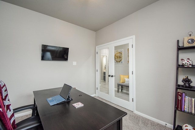 carpeted office featuring french doors and baseboards