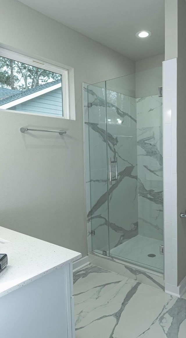 full bath featuring marble finish floor, a marble finish shower, recessed lighting, vanity, and baseboards