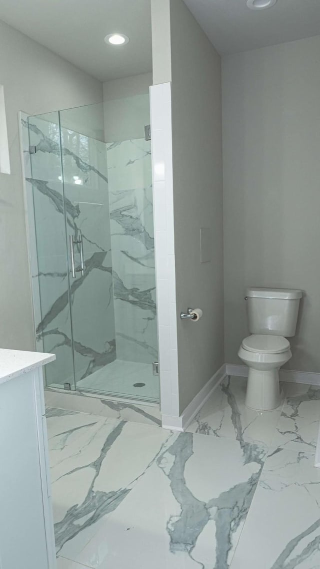 bathroom featuring a marble finish shower, marble finish floor, toilet, and baseboards