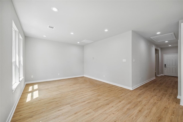 unfurnished room featuring recessed lighting, visible vents, light wood-style flooring, and baseboards