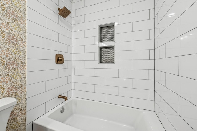 bathroom featuring shower / bath combination and toilet