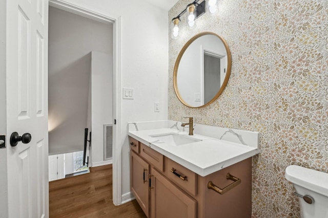 bathroom featuring toilet, wallpapered walls, visible vents, and vanity