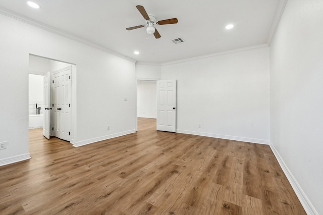 unfurnished bedroom with baseboards, visible vents, ornamental molding, wood finished floors, and recessed lighting