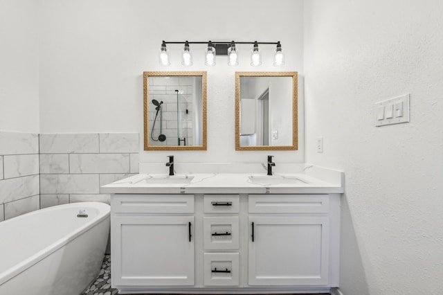 full bathroom featuring a sink, double vanity, a freestanding tub, and tile walls