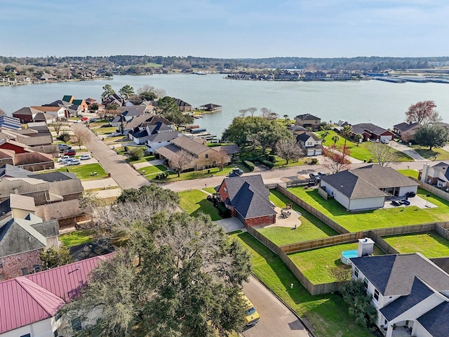 birds eye view of property with a water view and a residential view