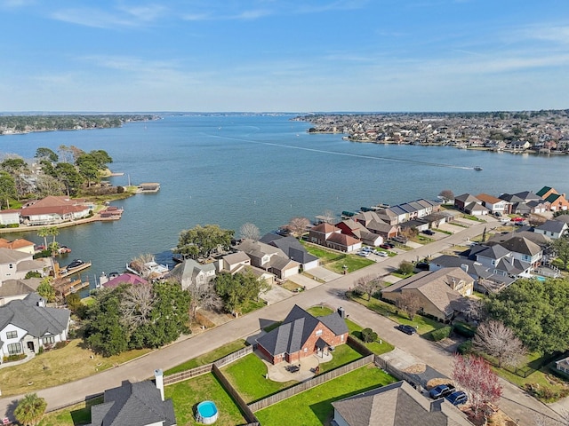 drone / aerial view with a residential view and a water view