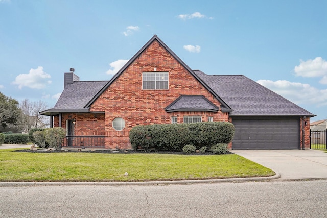 view of front of house with a shingled roof, concrete driveway, a chimney, a front lawn, and brick siding