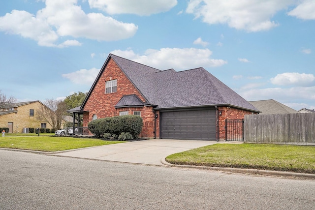 view of front of home with brick siding, roof with shingles, concrete driveway, an attached garage, and fence