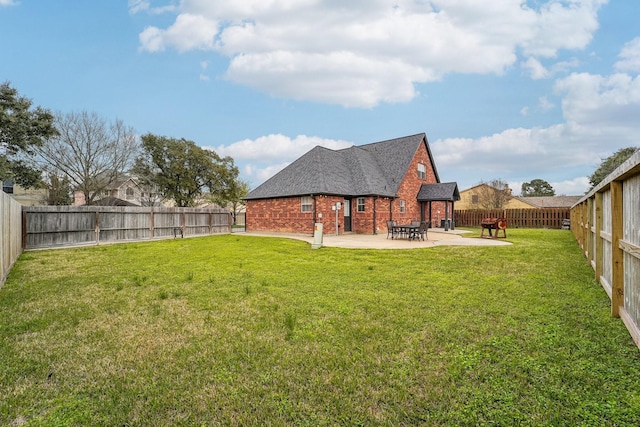 view of yard with a patio area and a fenced backyard