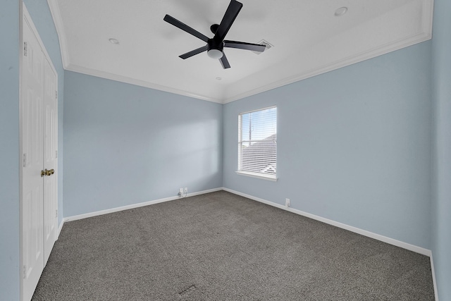 empty room featuring baseboards, dark carpet, a ceiling fan, and ornamental molding