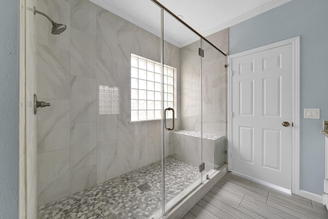 full bathroom with crown molding and a shower stall