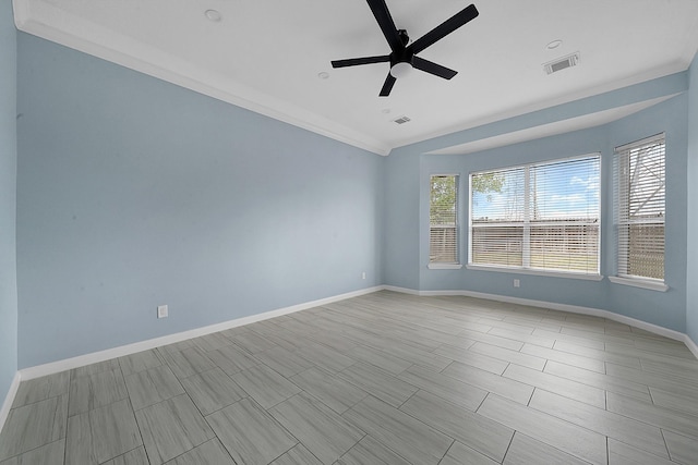 empty room with ceiling fan, visible vents, and baseboards