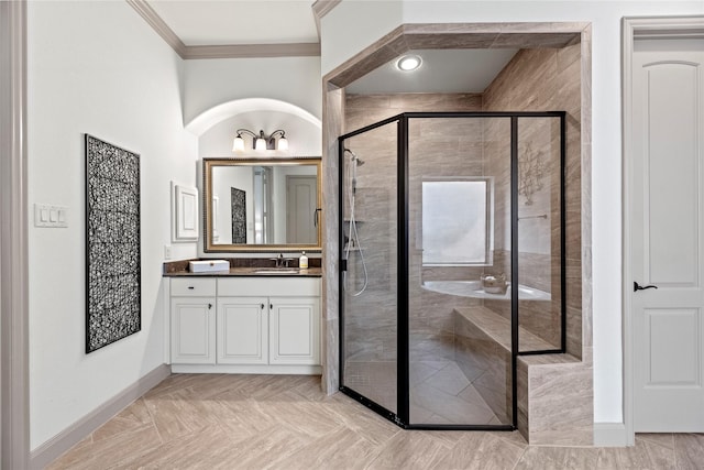 bathroom featuring a stall shower, baseboards, ornamental molding, and vanity