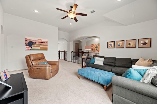 living area featuring arched walkways, recessed lighting, carpet floors, a ceiling fan, and visible vents