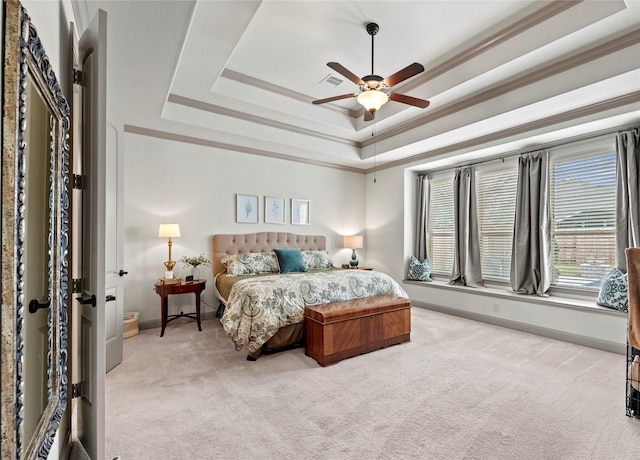 bedroom with light carpet, visible vents, baseboards, a raised ceiling, and crown molding