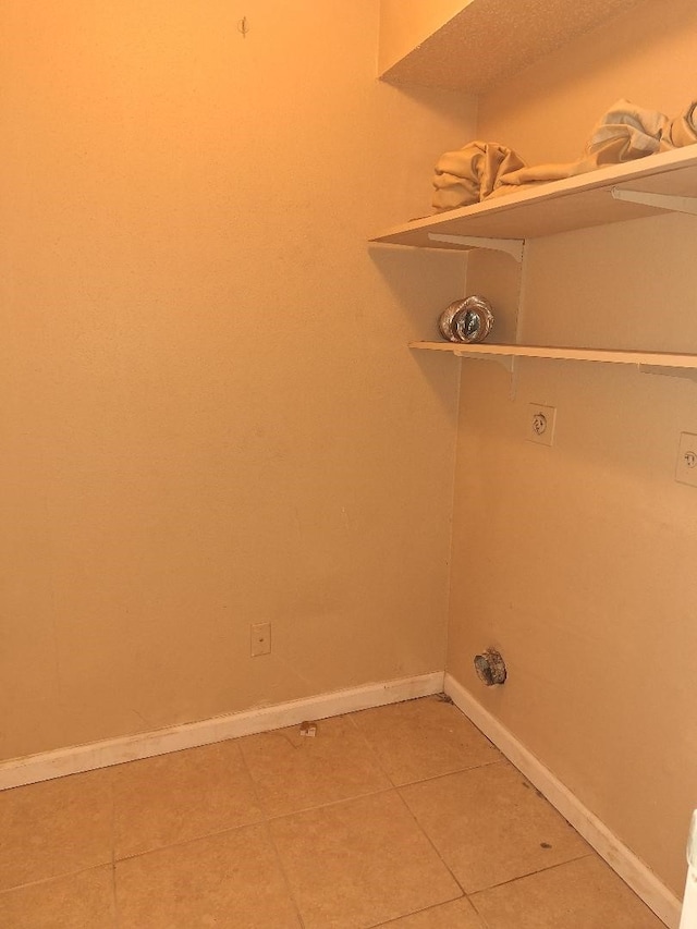 laundry room with baseboards, laundry area, tile patterned floors, and hookup for an electric dryer