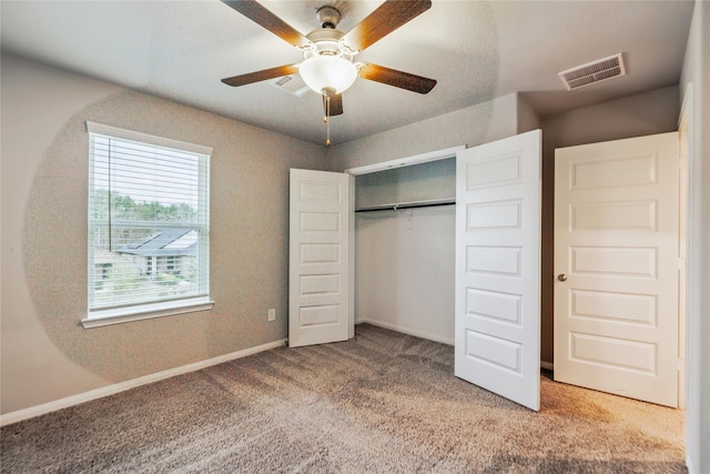 unfurnished bedroom featuring carpet floors, a closet, visible vents, and baseboards