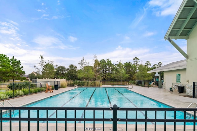 pool featuring fence and a patio