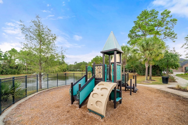 community jungle gym featuring a water view and fence