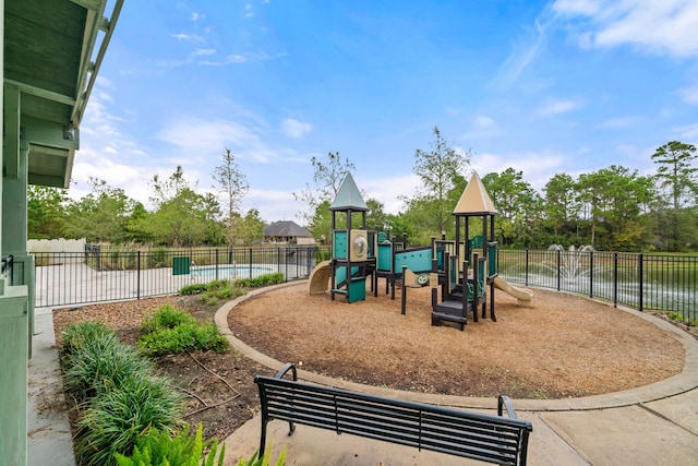 community play area featuring a water view and fence