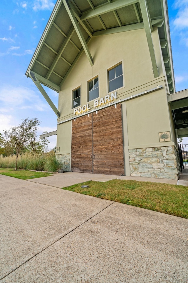 view of home's exterior with stone siding and stucco siding