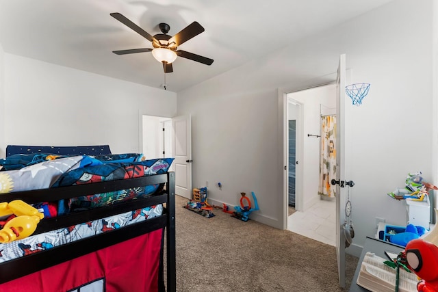 carpeted bedroom with a ceiling fan and baseboards