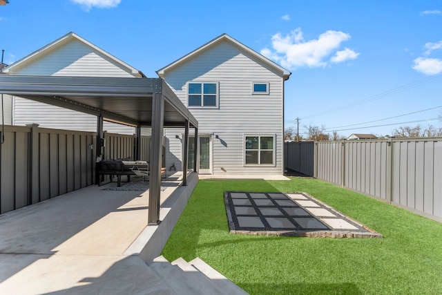 rear view of property with a fenced backyard, a patio, and a lawn