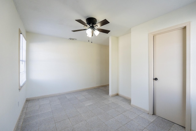 unfurnished bedroom with a ceiling fan, visible vents, and baseboards