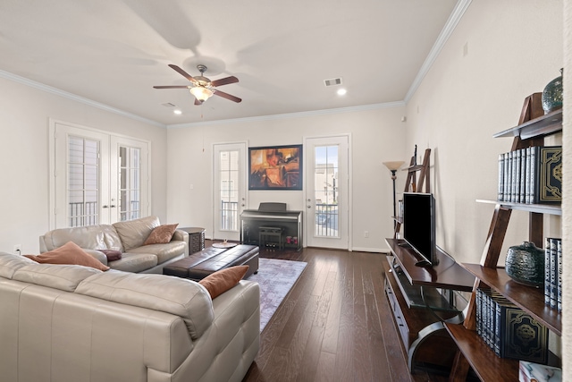 living room with ornamental molding, french doors, visible vents, and dark wood finished floors