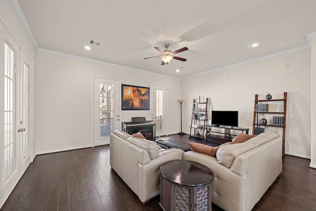 living area with dark wood finished floors, recessed lighting, visible vents, ornamental molding, and baseboards